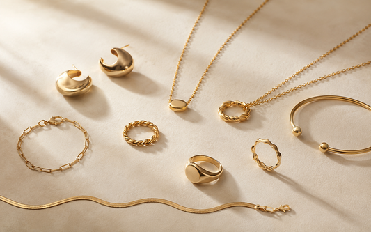 A curated jewelry capsule with earrings, layered necklaces, rings and a bracelet