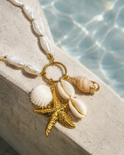 Close-up view of Aurelia Shell Starfish Charm Necklace by Zodiglow
