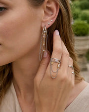 Detail view of Celestia Orbit Chain Drop Earrings by Zodiglow