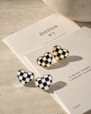 Close-up view of Checker Heart Stud Earrings by Zodiglow
