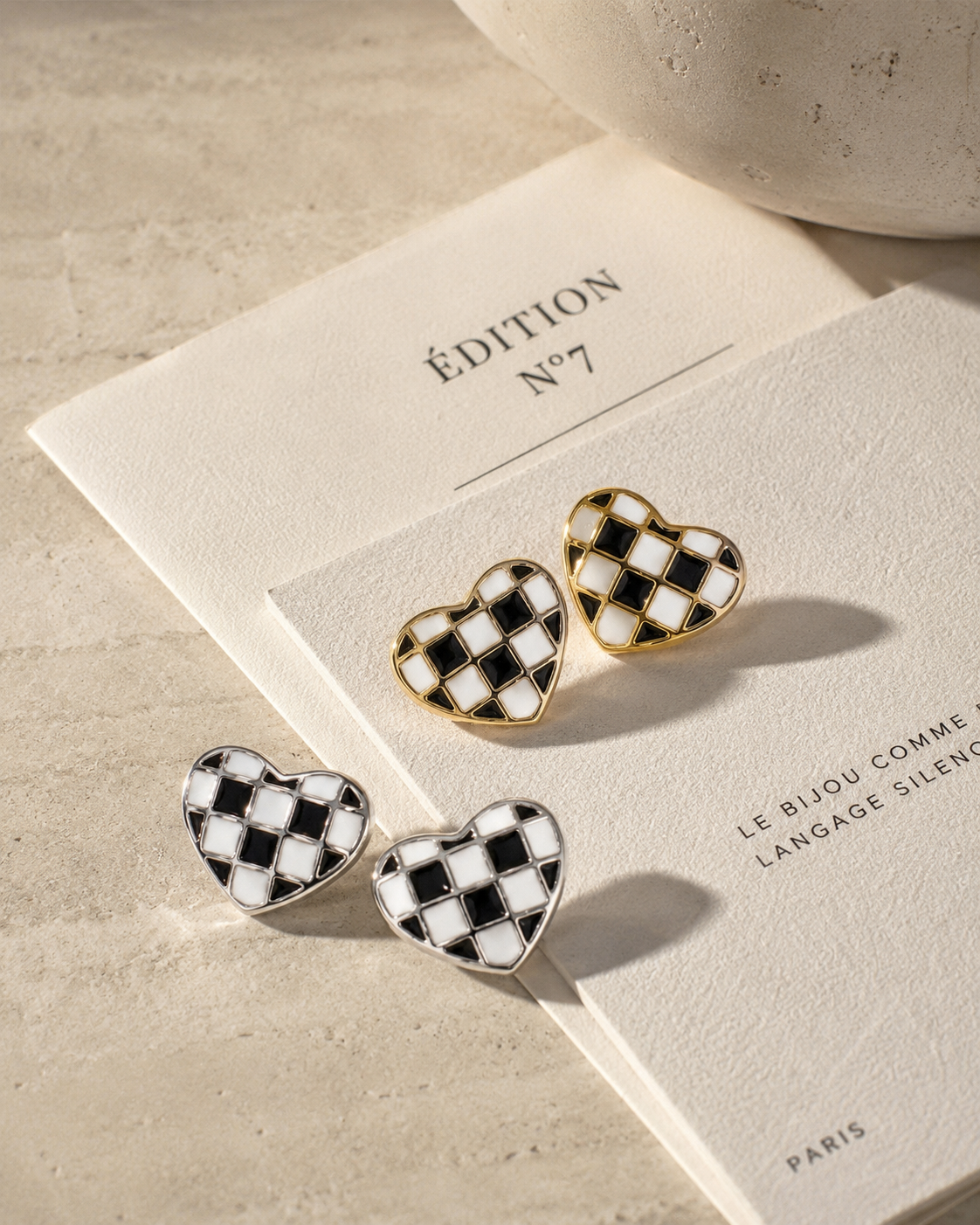 Close-up view of Checker Heart Stud Earrings by Zodiglow