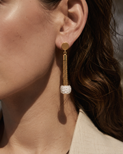 Close-up view of Lumière Gold Pavé Tassel Drop Earrings by Zodiglow