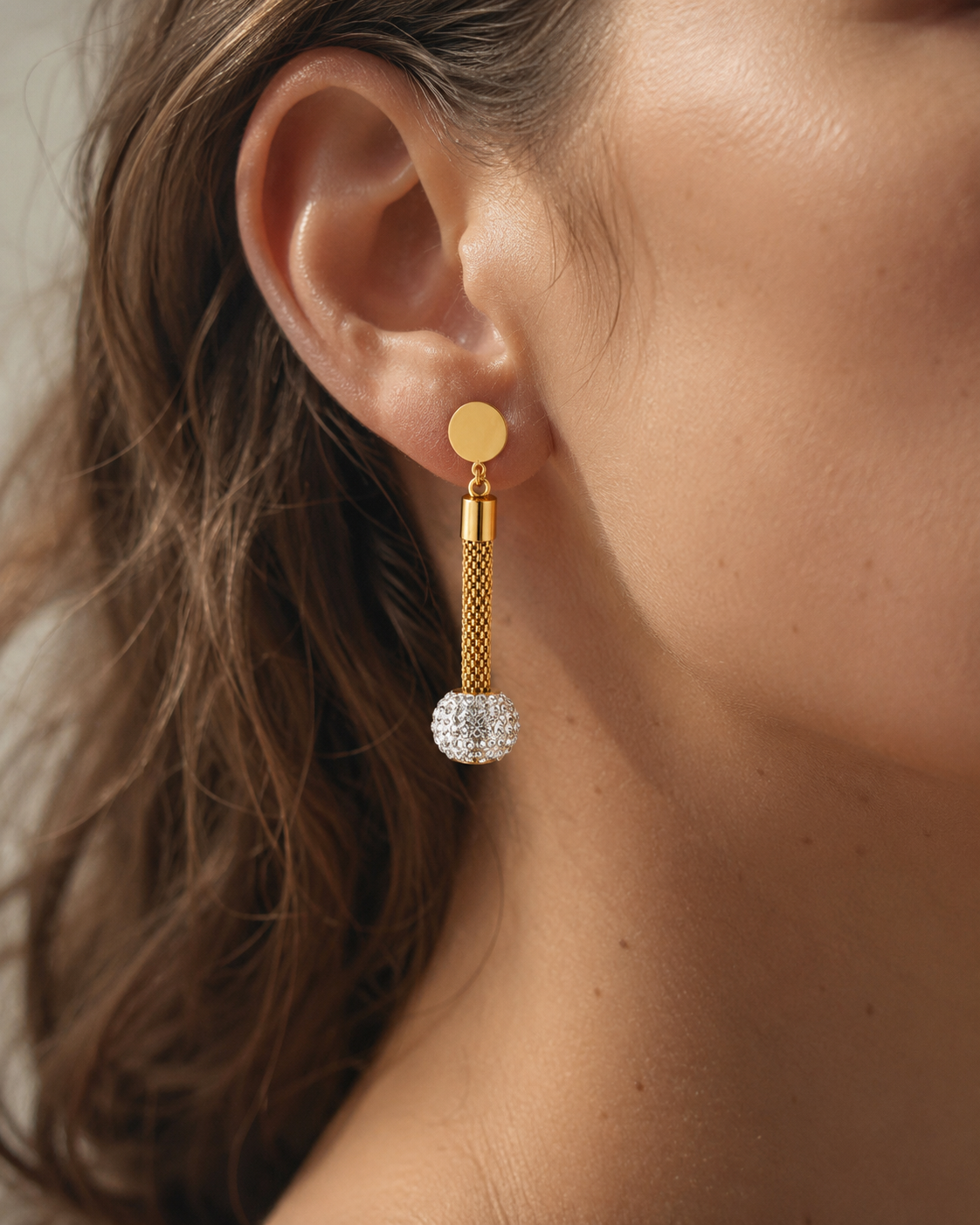 Styled view of Lumière Gold Pavé Tassel Drop Earrings by Zodiglow