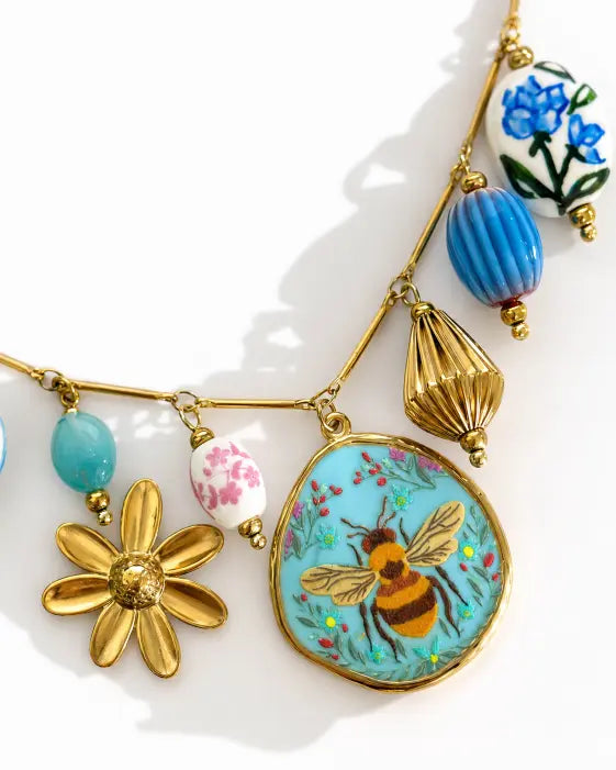 Detail view of Maribel Treasure Charm Necklace by Zodiglow