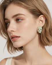 Close-up view of Monstera Enamel Stud Earrings by Zodiglow