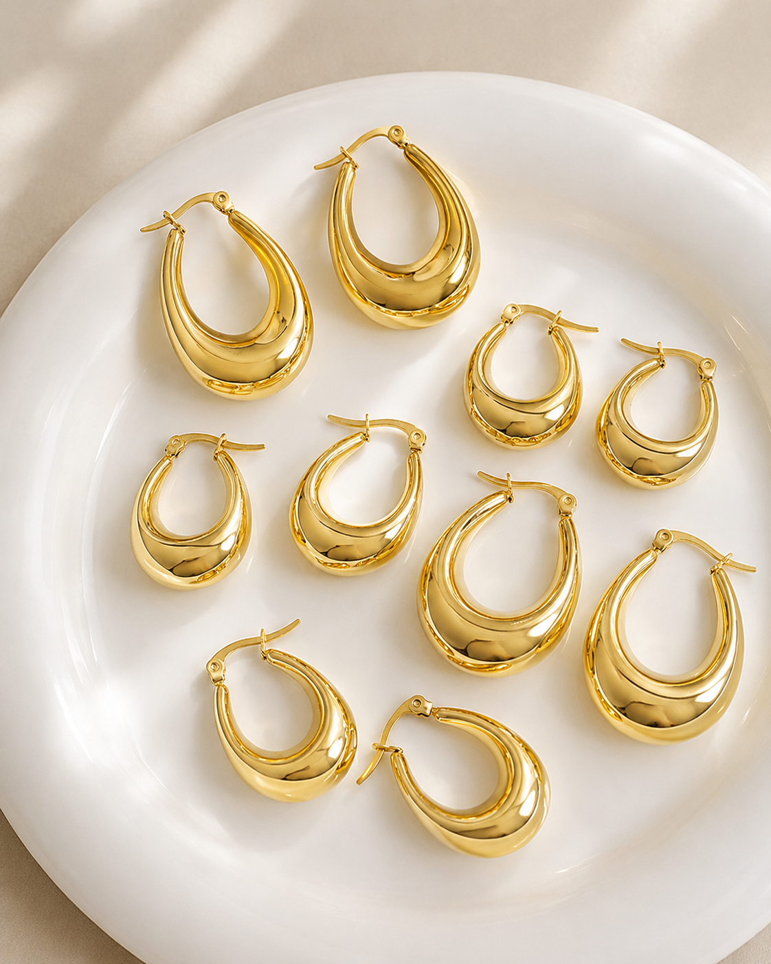 Detail view of Solenne Sculpted Teardrop Hoop Earrings by Zodiglow