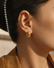 Detail view of Starlit Huggie Earrings by Zodiglow