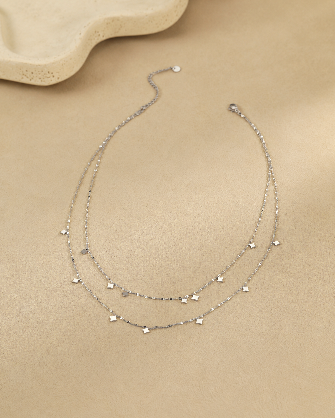 Close-up view of Stella Layered Star Necklace by Zodiglow